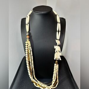 34" of Carved bone, bone, and brass‎ toned accent beaded necklace!